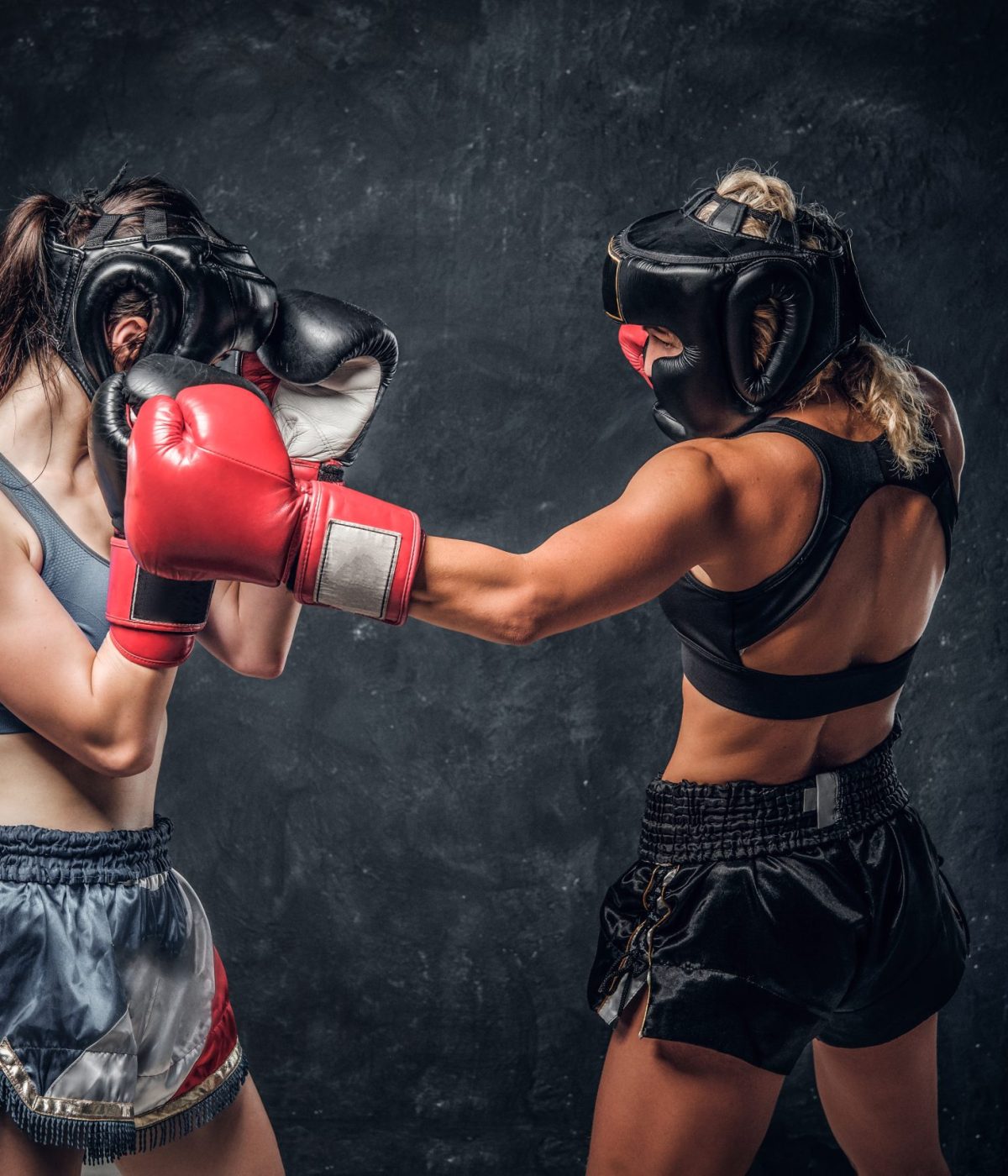 Process of fight between two female boxers, one of them got hit from another.